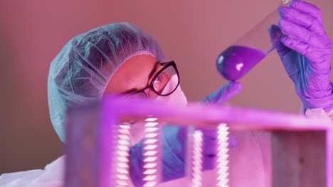 scientist studying liquid preparation on glass tube on a laboratory researching for a new test on coronavirus infection