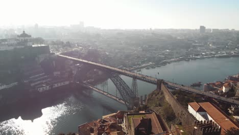4k aerial drone footage of the steel bridge spanning across the river channel of coastal city of porto in northwest portugal
