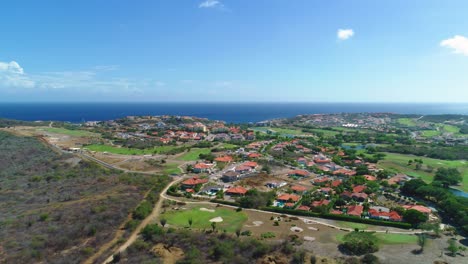 aerial trucking pan rises to reveal endless ocean horizon cloud view from homes on land