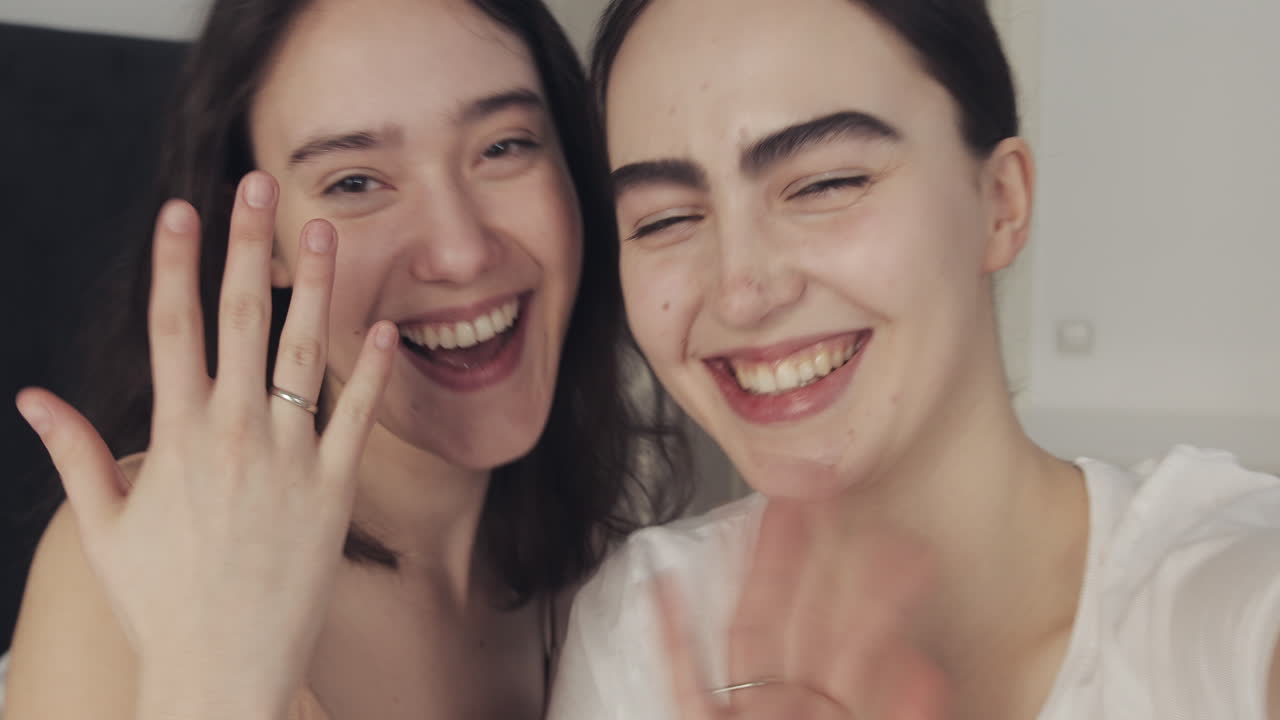Two smiling women friends together indoors