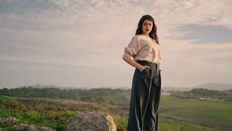 fashion girl standing landscape in stylish clothes. model on beautiful hill.