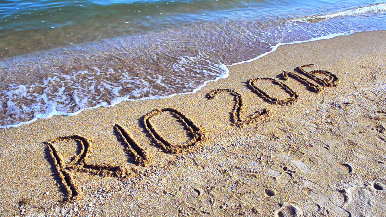 Rio 2016 an inscription on sand, the beach. Symbol Olympic game on sand, the beach