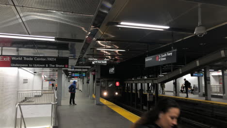 the world trade center cortlandt street subway station new york city.one train rumbles into station as camera pans over to words on mosaic tile wall.