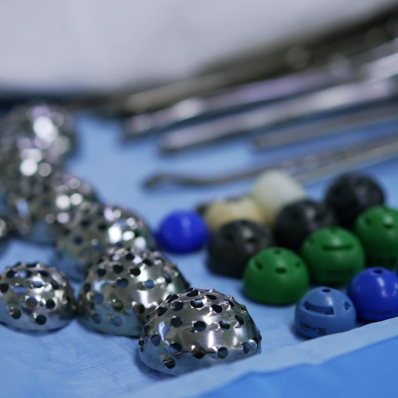 Metal tools and plastic elements for usage at arthroscopic operation. Close up. Blurred backdrop