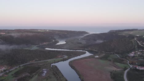 flying over the seixa river towards praia de odeceixe in the morning, aerial