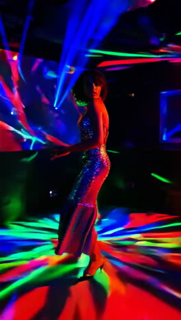 nightclub scene with woman in glitter dress and colorful lights
