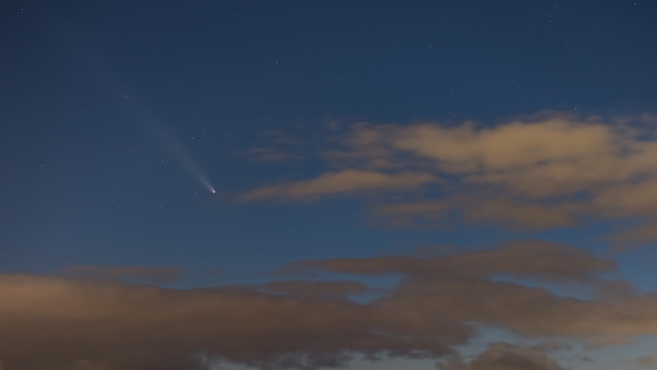The comet C2023 A3 (Tsuchinshan-ATLAS) appearing on the sky after sunset before it disappears in the clouds over the horizon