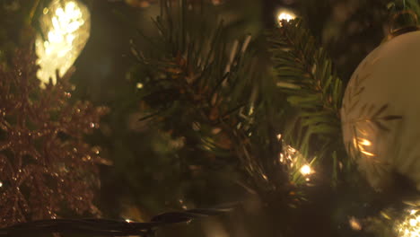 Christmas-tree-lights-and-ornaments-in-an-abstract-close-up,-bokeh,-slider-move