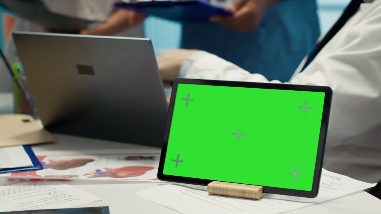 Medical team using tablet with green screen