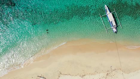 Hulhumale-Island,-Maldives---Beautiful-Scenery-Of-A-Tourist-Boat-Floating-in-the-Sea-With-White-Sand---Aerial-Shot