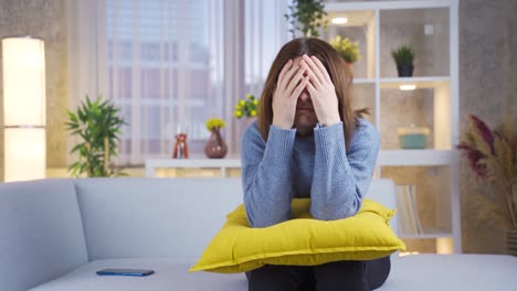 Sad-young-woman-sitting-alone-feeling-depressed.-Pillow-and-woman.