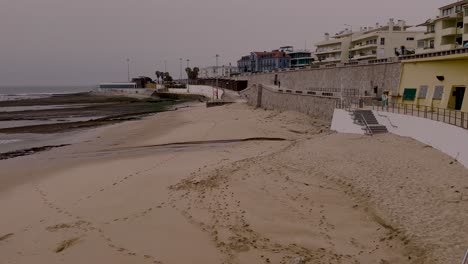 beach in lisbon portugal during the off autumn season, sandy shore landscape