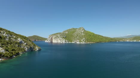 Cinematic-upwards-moving-4K-drone-clip-over-the-tropical-blue-waters-of-Toroni-in-Chalkidiki