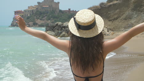 happy woman enjoying her summer vacation at the beach