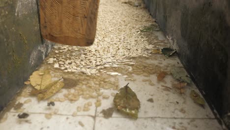 shot of a large container for cleaning coffee beans with water and using a wooden spatula to organise the cleaning process on plantation factory sierra nevada colombia slowmotion