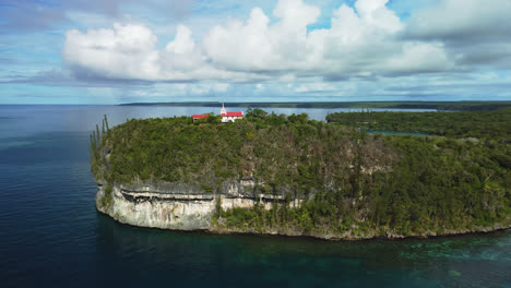 aerial arc shot around notre dame de lourdes chapel in lifou, new caledonia