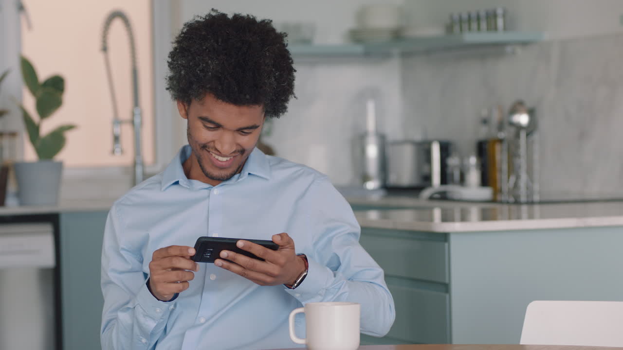 young man using smartphone texting social media messages browsing online enjoying mobile communication at home