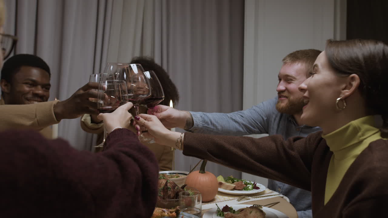 People Toasting with Wine at Dinner