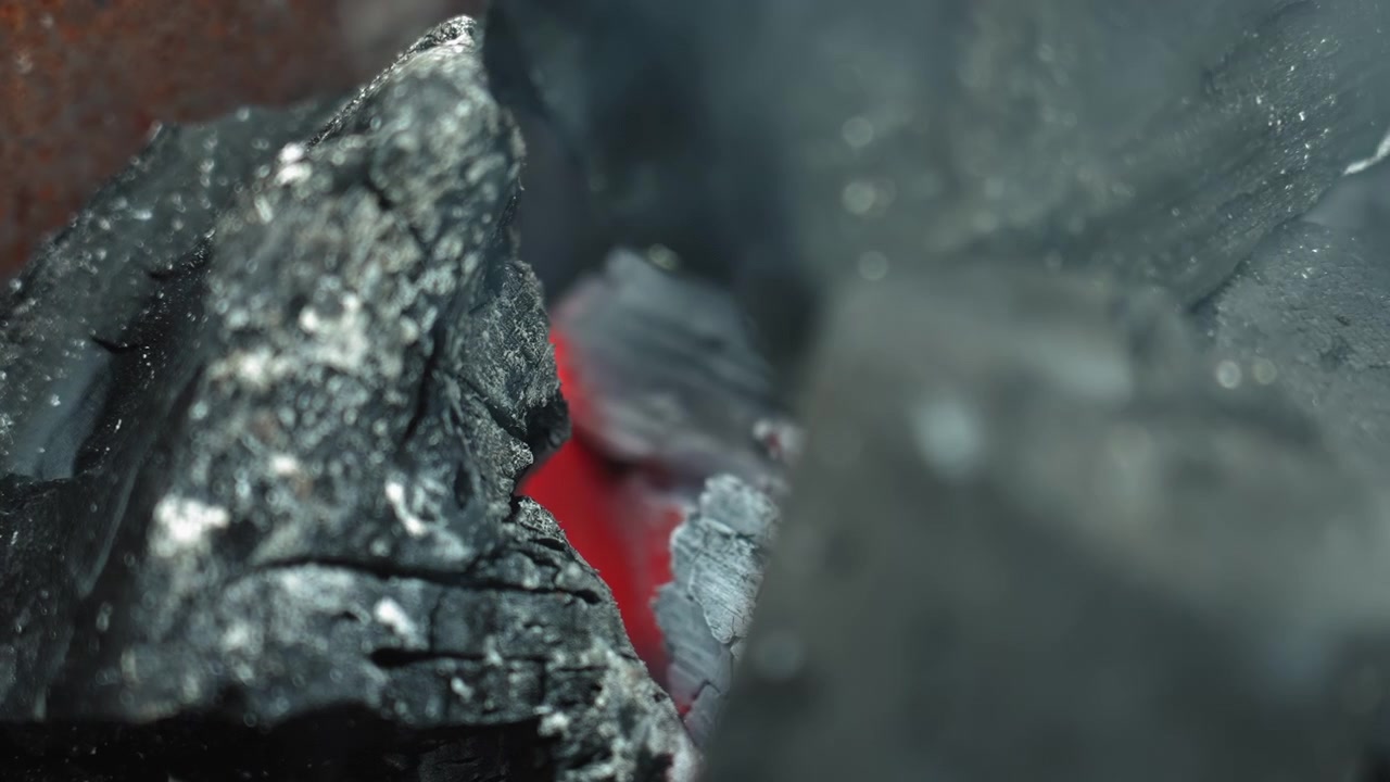 Close-up of Burning Charcoal with Red Embers and Smoke