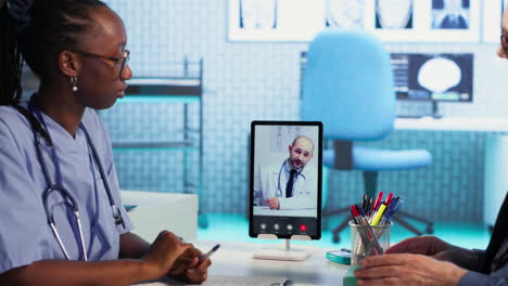 vertical video nurse discussing with patients while on videocall with an expert