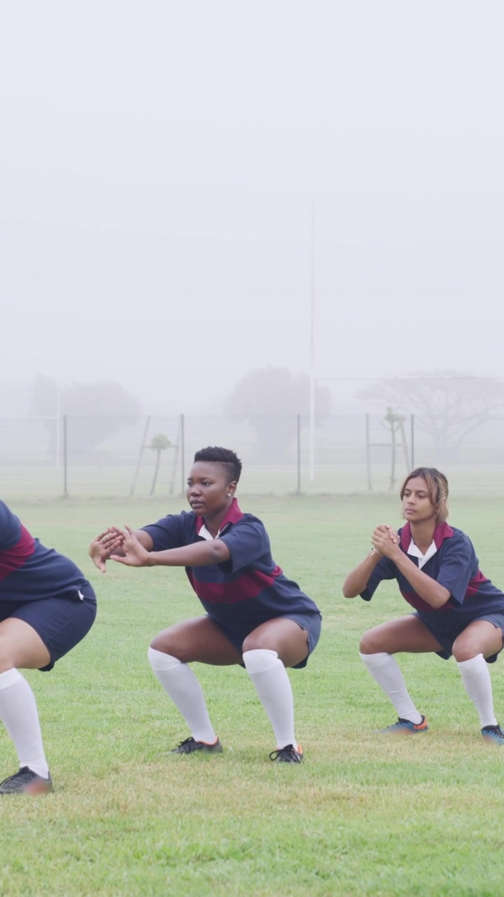 Female Rugby Players Warming Up on a Foggy Field