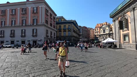 people walking in a historic square