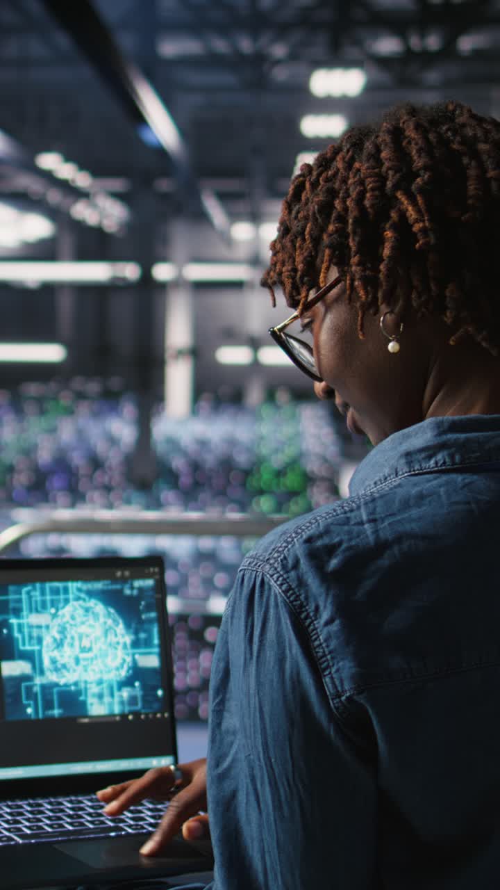 Vertical video Data center coworkers doing maintenance on mainframes handling AI