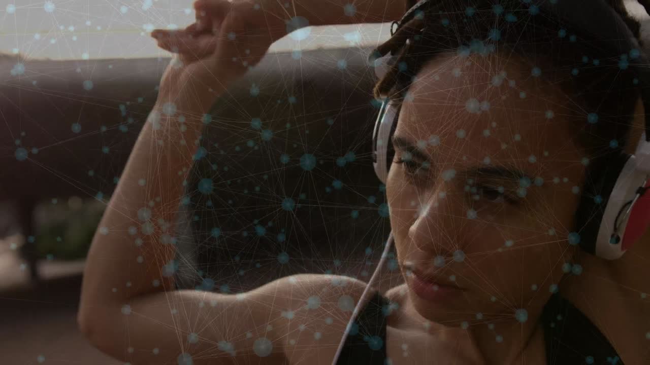 animación de conexiones sobre mujer biracial en forma con auriculares y estiramiento