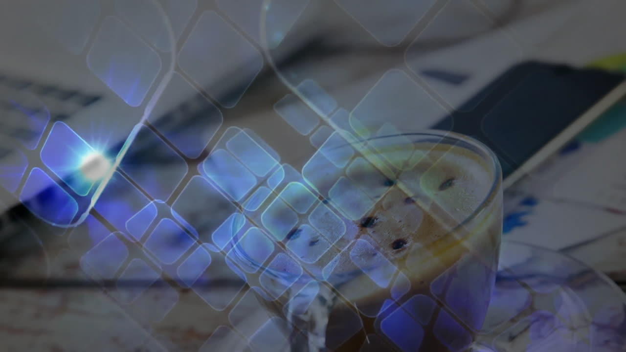 Glass mug sitting on desk, with frothy cappuccino next to laptop phone papers under digital overlay