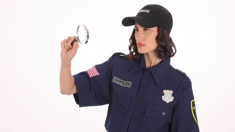 woman police officer investigating with a magnifying glass