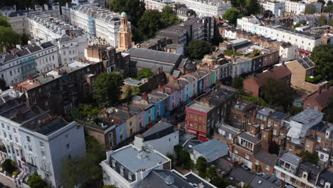 Various-houses-in-residential-district-of-city.-Church-with-tall-tower-between-buildings.-London,-UK