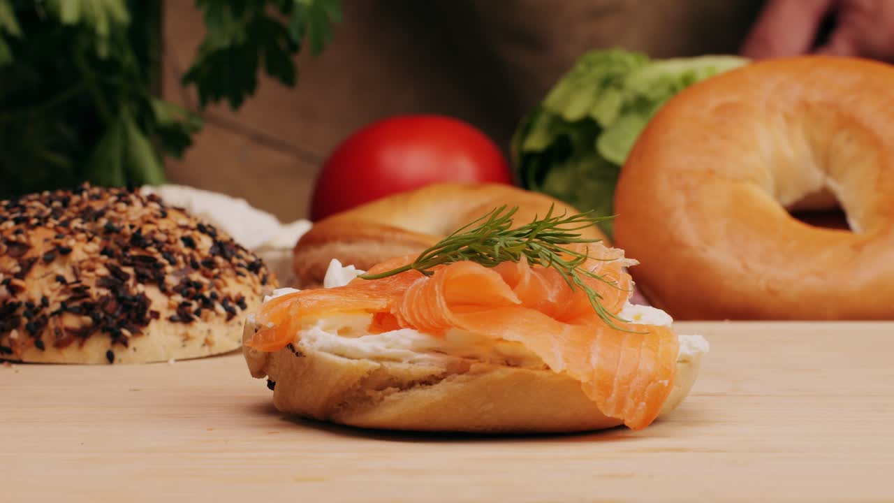 Bagel sandwich brunch, lunch plate of a bagel with smoked salmon and cream cheese and ham, close up morning cafe menu.