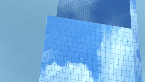 modern skyscraper facade with cloud reflections