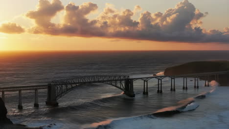 bridge over the ocean at sunset