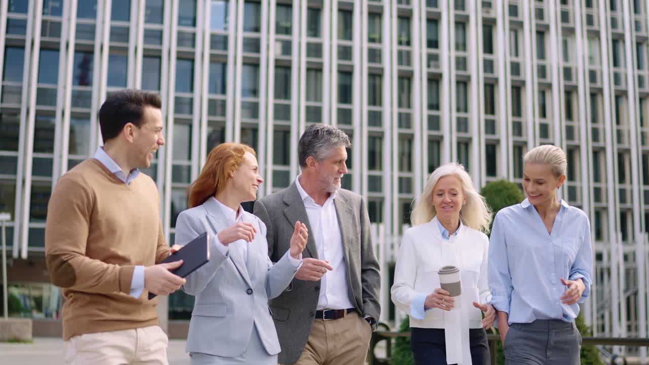 A group of business people walking and talking