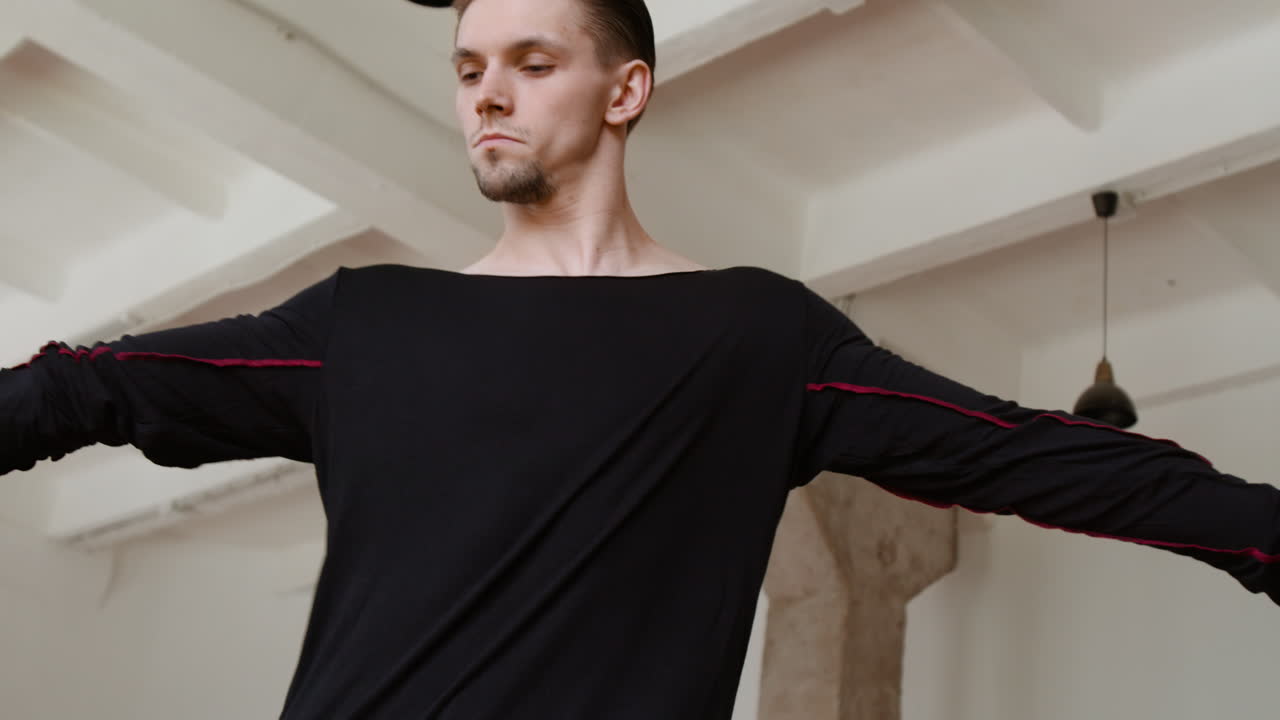 Male dancer practicing contemporary movements in a studio