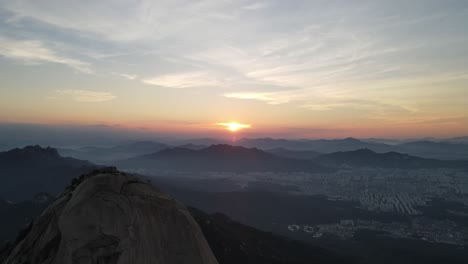 Aerial-shot-of-Seoul-city-and-Bukhansan-mountain-range-in-South-Korea