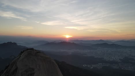 aerial shot of seoul city and bukhansan mountain range in south korea