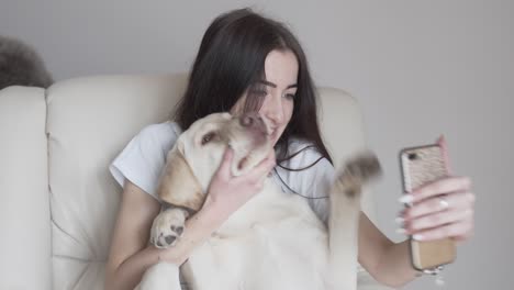 Female-dog-owner-grimacing,-making-faces-together-with-a-dog-for-taking-a-selfie