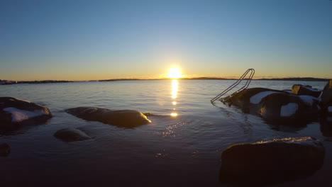 rocky shore with a metal stairs used for cold bathing in gothenburg, sweden