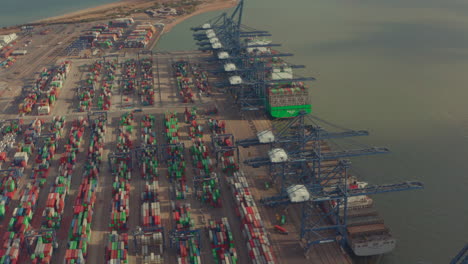 low aerial shot over container yard and loading cranes at port of felixstowe