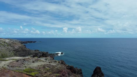 a dolly zoom from a drone captures the scenery of west maui, hawaii, from above, highlighting the coastline’s sweeping views, and lush terrain against the backdrop of the vast pacific ocean