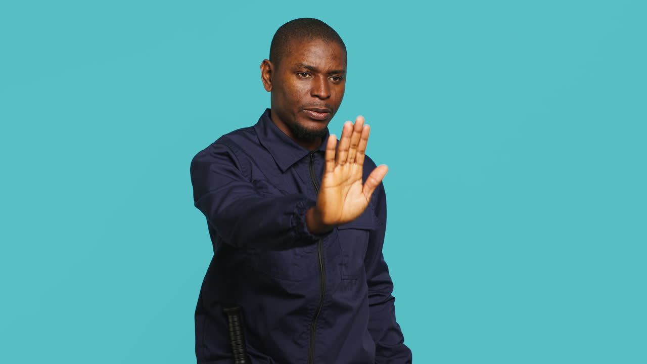 Private law enforcement worker showing halt hand gesture to trespasser