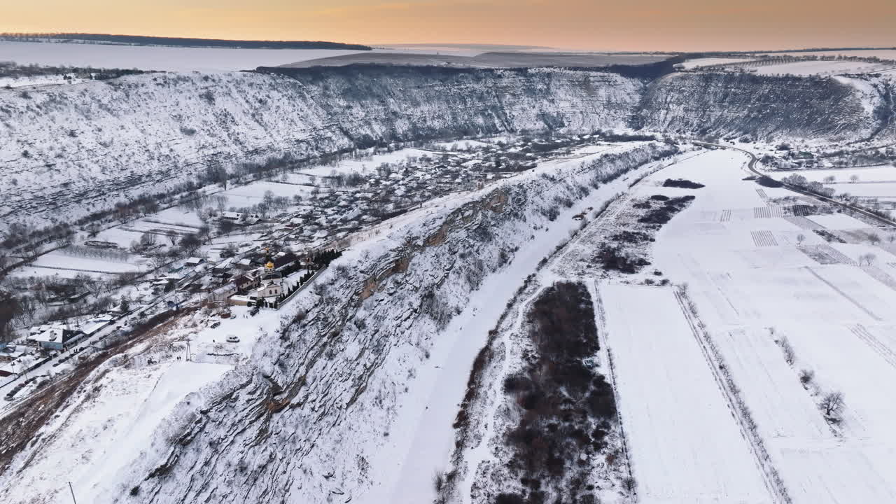 Aerial drone view of the Old Orhei covered in snow at sunrise. Monastery located on a hill in Moldova