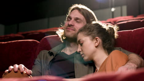 couple sitting in the cinema watching a movie 1