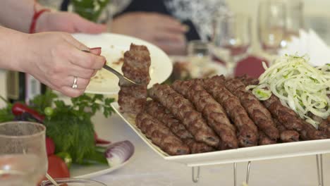 dinner table served with lula kebabs and fresh vegetables