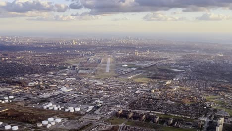 aerial view of toronto airport area as seen from airplane approaching pearson airport with runway for landing in background, ontario in canada