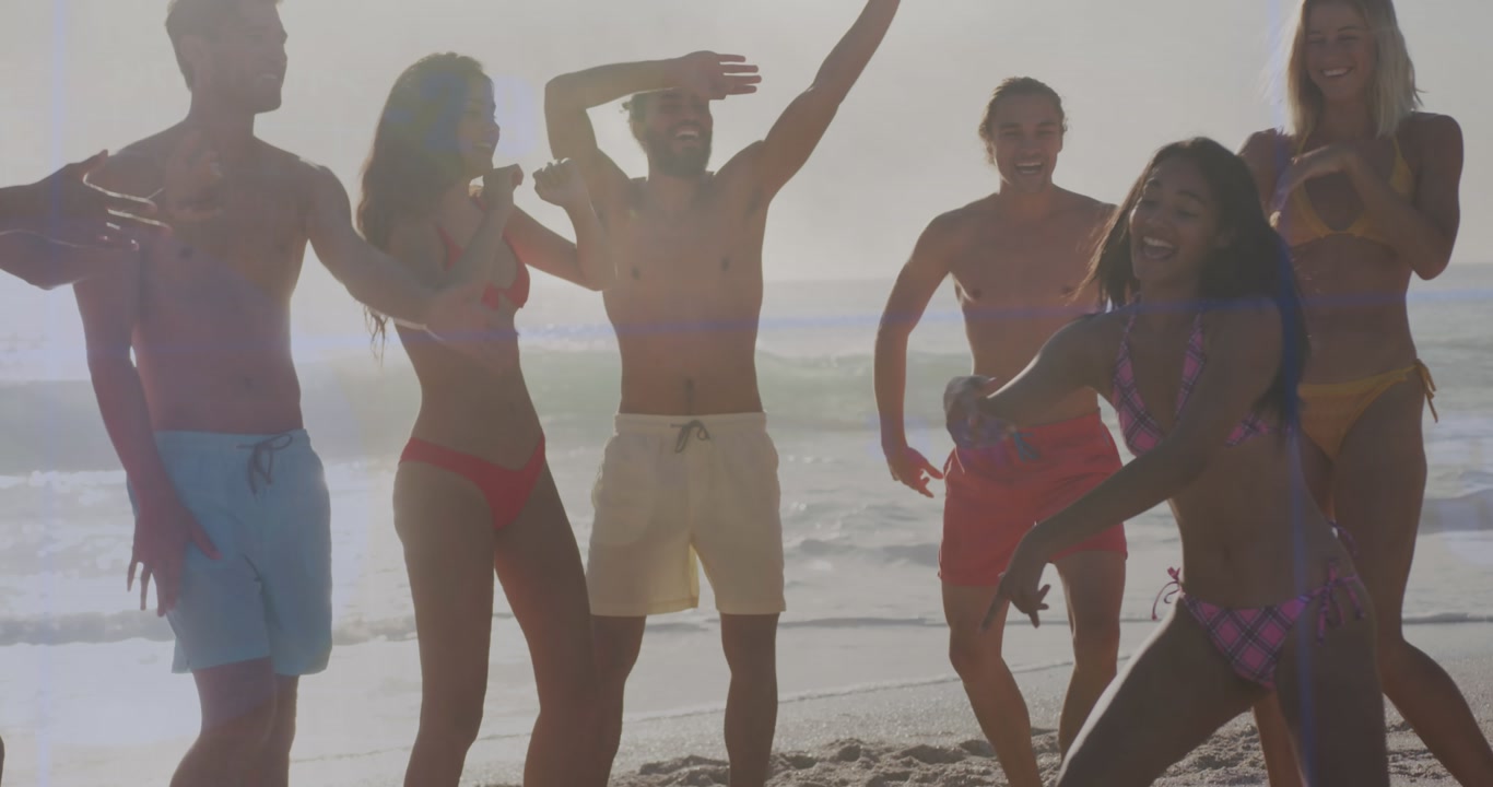 Happy Group of Young Friends Dancing on a Sunny Beach