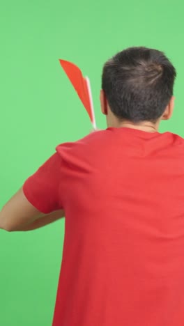 Rear view of a man waving a chinese pennant