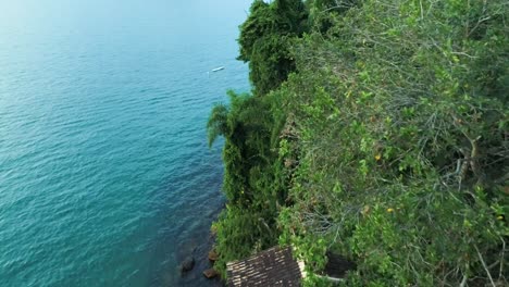 Drone-view-moving-over-the-ocean-restore,-people-having-fun-in-the-ocean-beach-hotel,-colorful-sunlight-in-the-ocean-beach